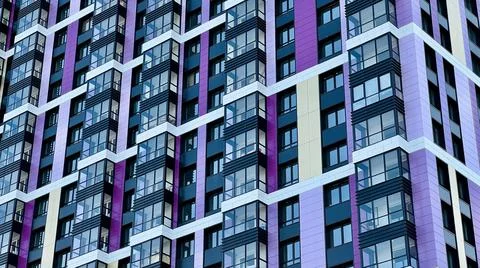 The facade of the building in purple,geometric patterns from windows and Foto stock