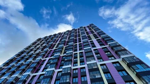 The facade of the building in purple,geometric patterns from windows and Stock Photos