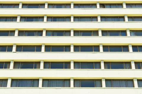 Facade of building with straight identical windows Stock Photos