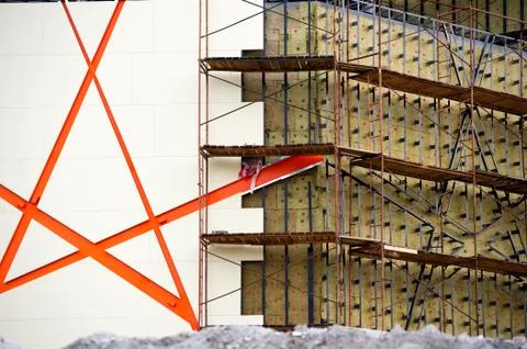 Facade of a building under construction. Border of finished part and draft. H Stock Photos