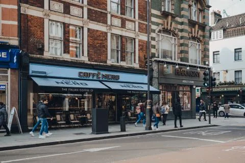 Facade of Cafe Nero, coffee house in London, UK, people walking by. Stock Photos