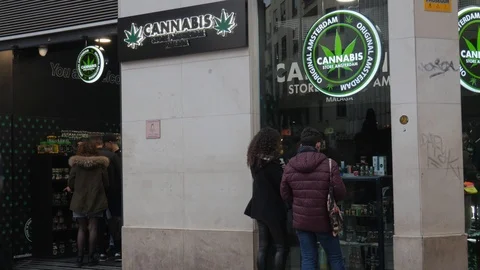 Facade of a cannabis store with people entering and getting out of the store. Stock Footage