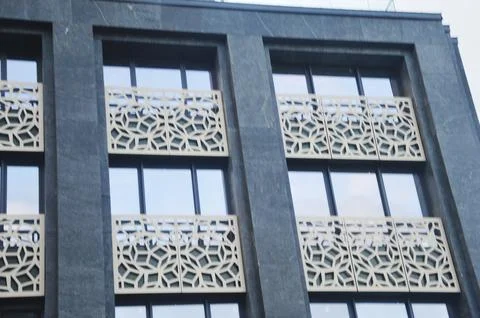 Facade cladding of the building. Decorative panels with an openwork pattern.. Stock Photos