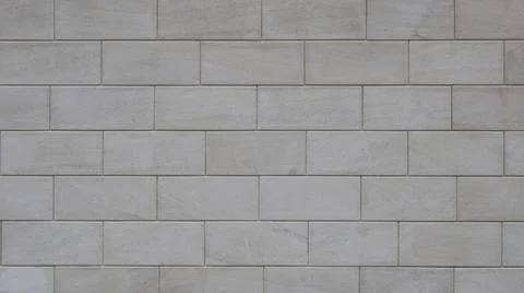 Facade cladding made of light-gray rectangular tiles Stock Photos