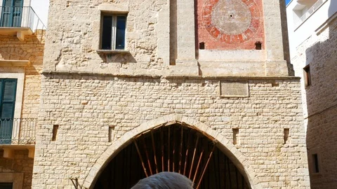 Facade of the clock tower positioned in front of the cathedral of Bitetto nea Stock-Footage 118989721