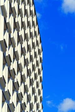 The facade of a concrete building with rectangular shapes is viewed from the Stock Photos