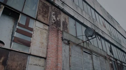 Facade of a dilapidated factory floor with a fixed spotlight on the wall Video stock 148490287