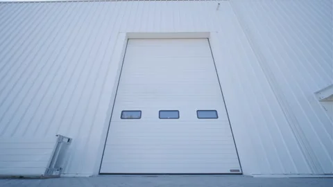 Facade (front view) of a large hangar lined with a metal profile. Stock Footage 251015521