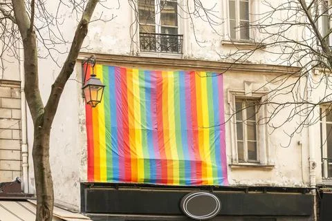Facade with gay pride flag instead of a window Paris, France. Rainbow flag of 写真素材