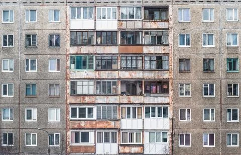 Facade of a grey multi-storey soviet panel building Stock Photos