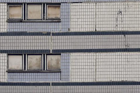 Facade of a grey multi-storey soviet panel building Stock Photos
