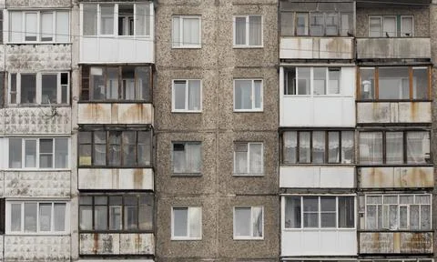 Facade of a grey multi-storey soviet panel building Stock Photos