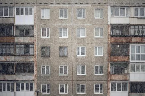 Facade of a grey multi-storey soviet panel building Stock Photos