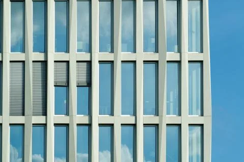The facade of a high building with some windows closed by blinds Stock Photos