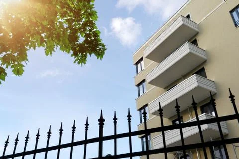 The facade of a high building with some windows closed by blinds Stock Photos