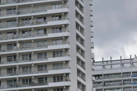The facade of a high building with some windows closed by blinds Stock Photos