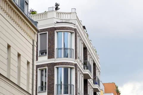 The facade of a high building with some windows closed by blinds Stock Photos