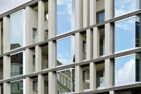 The facade of a high building with some windows closed by blinds Stock Photos