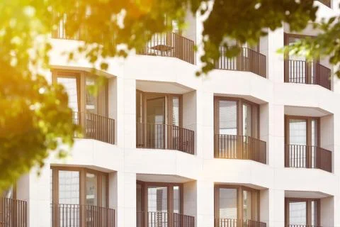 The facade of a high building with some windows closed by blinds Stock Photos