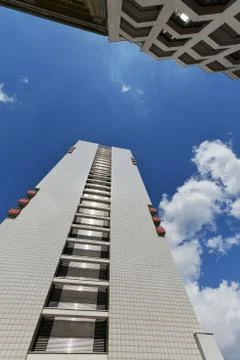 The facade of a high building with some windows closed by blinds Stock Photos