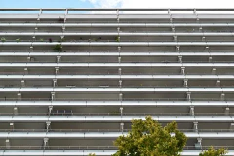 The facade of a high building with some windows closed by blinds Stock Photos