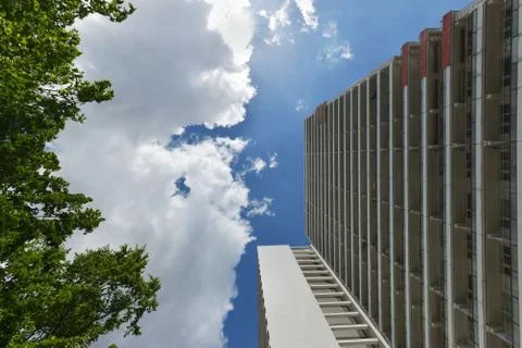 The facade of a high building with some windows closed by blinds Stock Photos