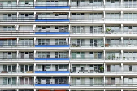 The facade of a high building with some windows closed by blinds Stock Photos