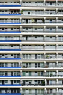 The facade of a high building with some windows closed by blinds Stock Photos