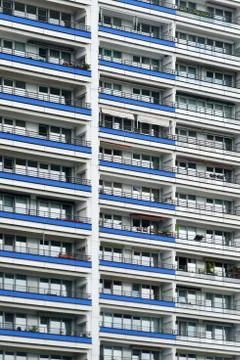 The facade of a high building with some windows closed by blinds Stock Photos