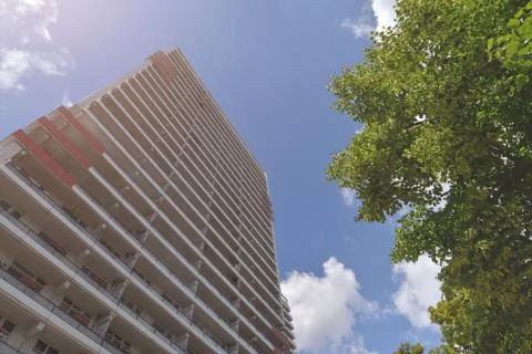 The facade of a high building with some windows closed by blinds Stock Photos