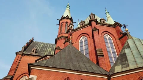 Facade of historic red brick catholic church showcasing gothic architecture in Video stock 342028625