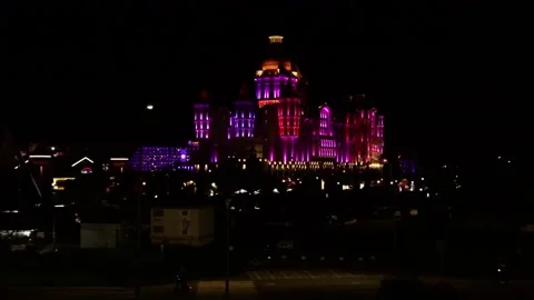 The facade of the hotel, illuminated by multicolored lanterns at night. Stock Footage 221304486