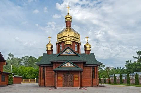 Facade log church with three gilded domes Stock Photos