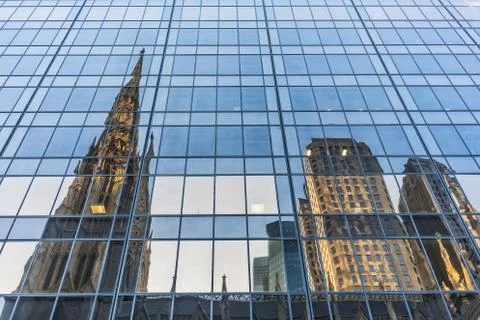 Facade of mirrored building with reflection of new york city. Stock Photos