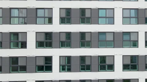 Facade of a modern gray building of residential complex close-up, urban geometry Stock Footage 243548229