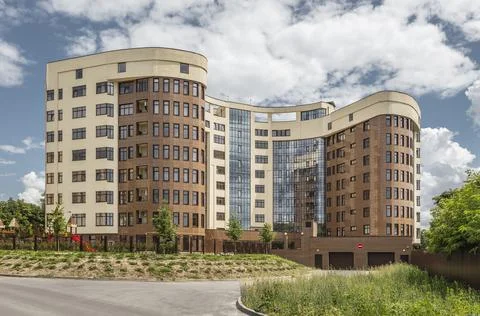 Facade of modern multi-storey brown beige building in the city. Space for text Stock Photos