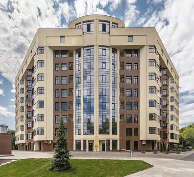 Facade of modern multi-storey brown beige building in the city. Space for text Stock Photos