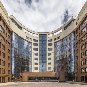 Facade of modern multi-storey brown beige building in the city. Space for text Stock Photos