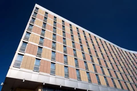 Facade of a modern, multi-storey building made of concrete and glass Stock Photos
