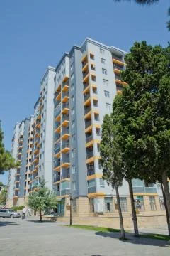 Facade of modern multi-storey new residential orange building near BAku . New Stock Photos