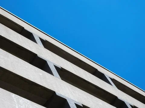 Facade of a multi-level car parking on a background of blue sky Stock Photos