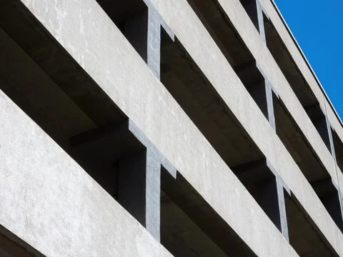 Facade of a multi-level car parking on a background of blue sky Stock Photos