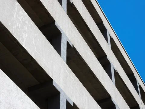 Facade of a multi-level car parking on a background of blue sky Stock Photos