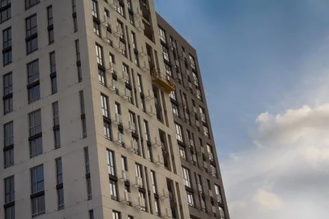 Facade of a multi-storey building under construction against the sky Stock Photos