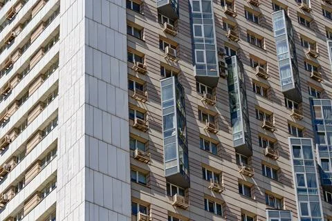Facade of a multi-storey modern building. Typical city development. Stock Photos