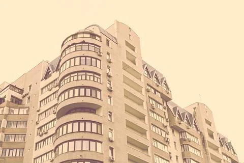 Facade of a multi-storey modern building. Typical city development. Stock Photos