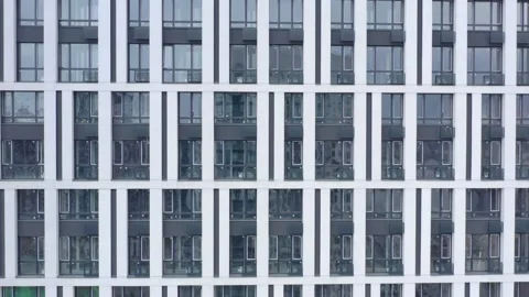 Facade of a multi-storey office  building with stained-glass windows. Stock Footage 151702933