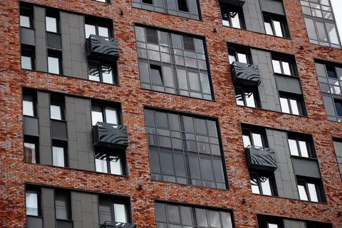 Facade of a new modern multi-storey brick house with compartments for a split Stock-Fotos