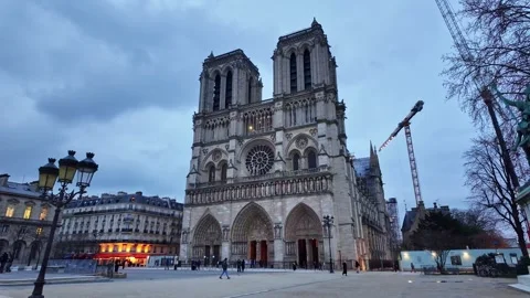 Facade of Notre-Dame de Paris after reconstruction, restoration cranes in Stock Footage 302946648