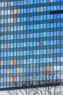 Facade of an office building with the reflection of the sky in the windows Stock Photos
